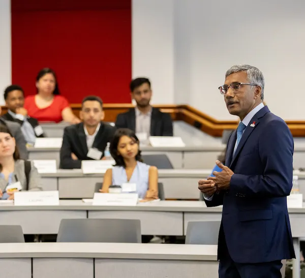 Dean Konana addresses a room full of people.