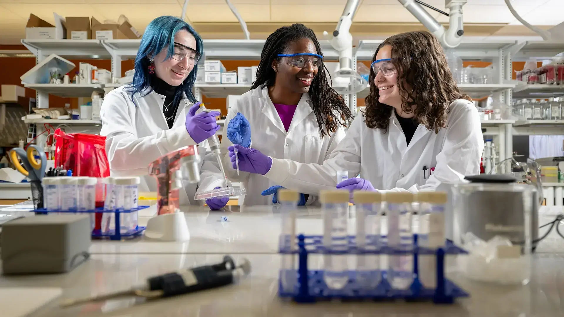 Student at a lab with pipettes and test tubes