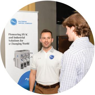 2 students in front of a presentation board