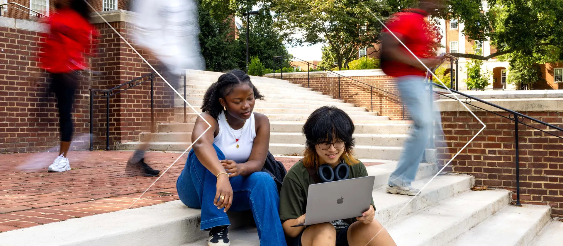 students on a laptop outside
