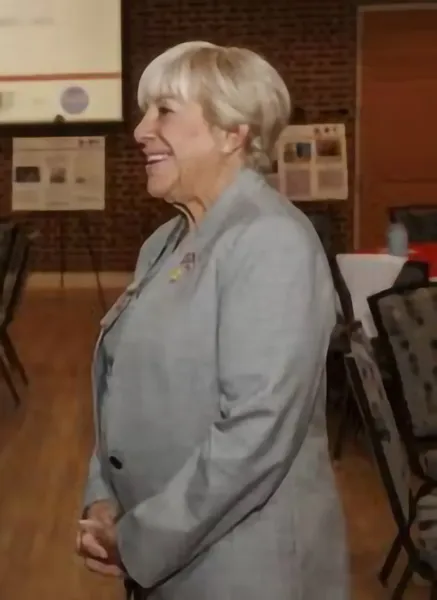 Woman looking to the side, dressed formally