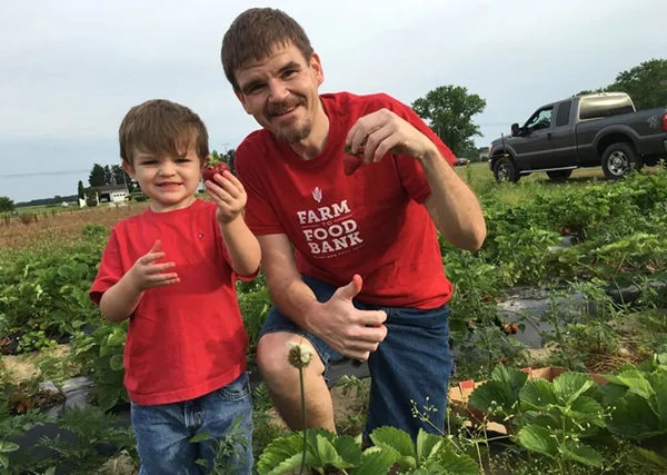 a man and boy smiling in a field